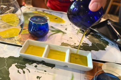Greek extra virgin olive oil being poured into a tasting dish during an olive oil tasting in Athens.