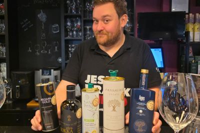 Greek olive oil tasting presentation with extra virgin olive oil bottles and tasting glasses in Athens.